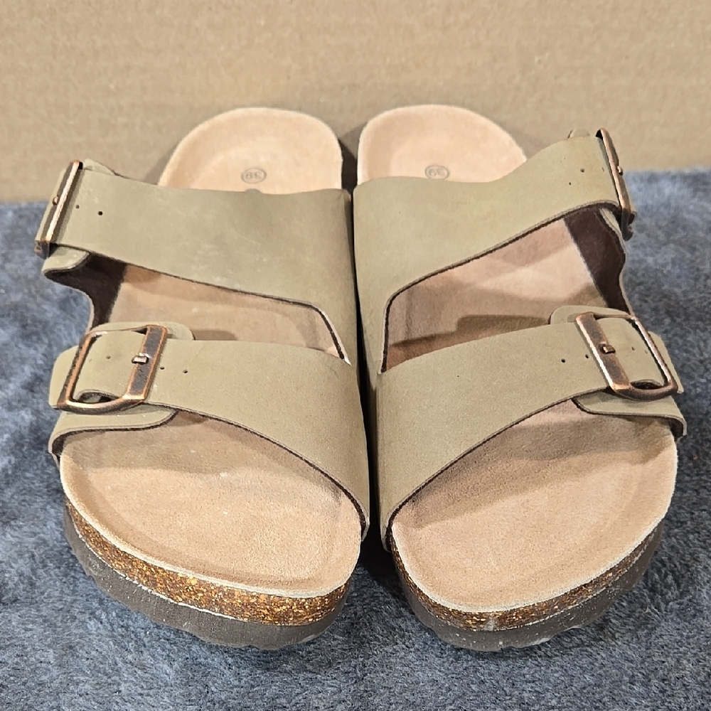 Odoly women's sandals in a light brown color with adjustable straps and buckle.